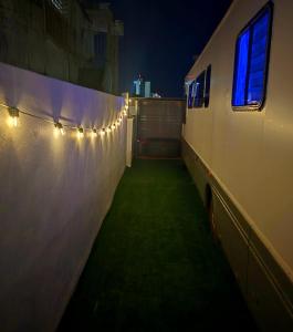 a hallway with lights on the side of a building at Gray Box in San Juan