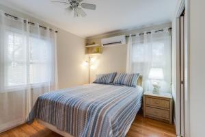 a bedroom with a bed and a ceiling fan at Maryland gardens 19c in Rehoboth Beach