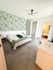 a bedroom with a bed and a wall mural at Novea Apartments - Comodi Appartamenti con Parcheggio & Wi-Fi vicino Taormina in Taormina