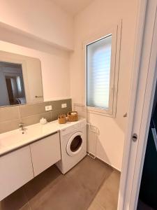 a bathroom with a washing machine and a sink at Novea Apartments - Comodi Appartamenti con Parcheggio & Wi-Fi vicino Taormina in Taormina +37 photos