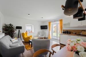 a kitchen and living room with a table and chairs at Chalupa Kozárovice in KozÃ¡rovice