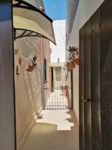 an alley with an open door to a building at A casa di Marisa in Casamassella