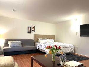 a living room with a bed and a couch at Cozy Master Room near Washington in Annandale