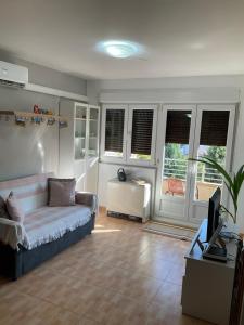 a living room with a couch and a tv at Ávila Apartment - Full Centric Flat with Amazing Views in Negreira