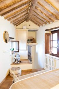 a room with white walls and wooden ceilings at Il Piccolo Fienile in Gradoli +25 photos