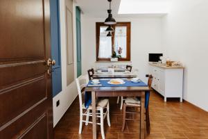 a dining room with a blue table and chairs at Bed & Breakfast Memory in Castelbasso