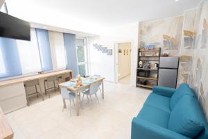 a living room with a blue couch and a table at Casa Giardina in Catania