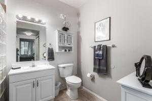 a white bathroom with a toilet and a sink at Southern #1064 Mesa in Mesa +19 photos