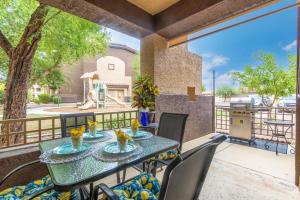 a patio with a table and chairs on a balcony at Southern #1064 Mesa in Mesa