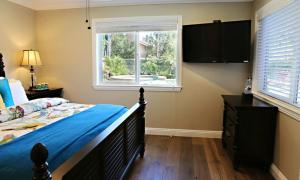 a bedroom with a large bed and a window at Upscale 6 Bed, 5 Ba, New Pool W/Jacuzzi, 1/2 Mile Walk to Disney in Anaheim