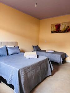 Ένα ή περισσότερα κρεβάτια σε δωμάτιο στο Casa moderno Luar