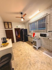 a kitchen with a counter and a stove top oven at Local Hostel e Suites Belem in Belém