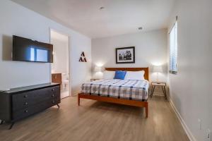 a bedroom with a bed and a flat screen tv at Ocean Park 08 in San Diego