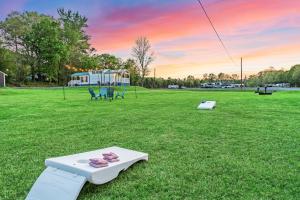 a game system sitting on the grass in a field at Luxury Tiny House Mins to Lake, Downtown Guntersville Boat Parking in Guntersville