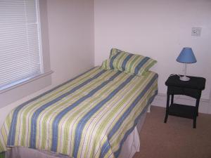 a bedroom with a bed and a lamp on a table at Rolling road 3 in Rehoboth Beach