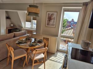 ein Wohnzimmer mit Tisch, Stühlen und Sofa in der Unterkunft Apartament Morska Harmonia in Ustka + 3 Fotos