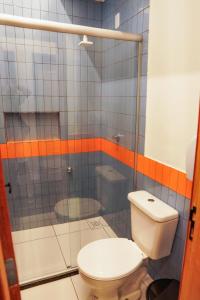 a bathroom with a toilet and a shower at Local Hostel e Suites Belem in Belém