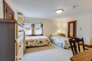 a bedroom with two beds and a desk and a table at Hickman street 208a in Rehoboth Beach