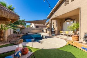 a backyard with a swimming pool and a house at Harrison Chandler in Chandler
