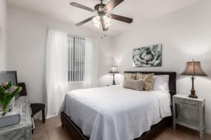 a white bedroom with a bed and a ceiling fan at Southern #1064 Mesa in Mesa