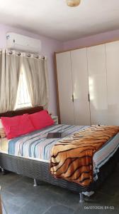a bedroom with a large bed with red pillows at Sítio Conquista Feliz in Nova Iguaçu +80 photos