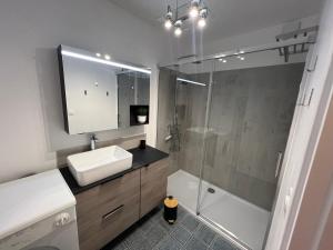 a bathroom with a shower and a sink and a tub at Mathilda front de mer 9e étage in Le Touquet-Paris-Plage +42 photos