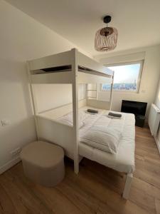 a white bunk bed in a room with a window at Mathilda front de mer 9e étage in Le Touquet-Paris-Plage