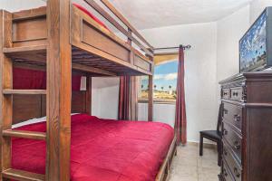 a bedroom with a bunk bed with a red bedspread at Princesa De Penasco in Punta Penasco New +15 photos
