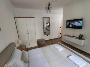 a living room with a bed and a flat screen tv at Studio 23 in Banja Luka