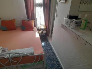 a small bedroom with a bed and a window at Studio abir in Saint-Ouen