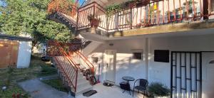 anterior view of a house with stairs and a balcony at Baosići,dvije spavaće sobe in Baošići