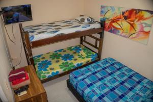 a bedroom with two bunk beds and a bed at Rincon Samario in Santa Marta