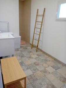 a bathroom with a ladder and a tiled floor at Le gîte de notre histoire in Épégard +16 photos