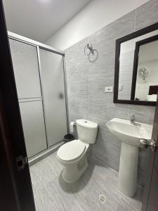a bathroom with a toilet and a sink at Santa Elena Hotel in Ocaña +28 photos