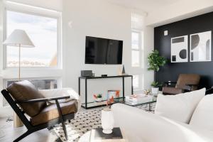 a living room with a couch and a table at Serenity in Style | Espadin LoHi in Denver