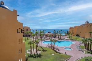 a view of a resort with a pool and palm trees at Princesa De Penasco in Punta Penasco New