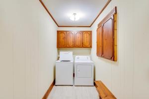 a kitchen with a white refrigerator and wooden cabinets at Deck and Game Room Mountaintop Hideaway in Tiger! in Tiger