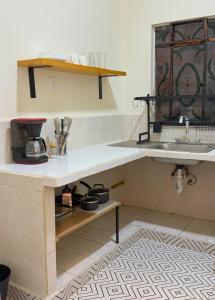 a kitchen with a sink and a counter with utensils at Loft Americana Stay Chapultepec Guadalajara in Guadalajara +2 photos