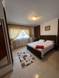 a bedroom with a large bed and a window at Location Haut de Gamme - Marina Smir in Marina Smir