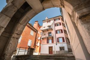 a view of a building through an archway at Hotel All'Arco in Trieste