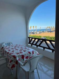 a bedroom with a table and a view of the beach at Location Haut de Gamme - Marina Smir in Marina Smir
