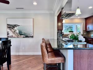 a kitchen with a island with a counter top at Cute 3 bedroom 2 bath home near Convention Center & Disney in Anaheim