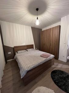 a bedroom with a bed and a white ceiling at Cloud Nine Escape in Pristina