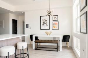 a dining room with a white table and chairs at Serenity in Style | Espadin LoHi in Denver