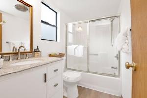 a white bathroom with a toilet and a shower at Bear meadow woods condo #2341 in Big Bear Lake