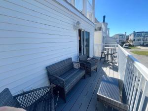 デューイ・ビーチにあるRodney avenue 107dの家の脇に二脚のベンチがある玄関