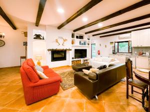 a living room with orange furniture and a fireplace at Monte do Trancoso in Alvito