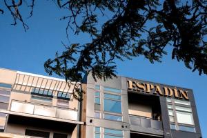 a building with a sign on top of it at Serenity in Style | Espadin LoHi in Denver