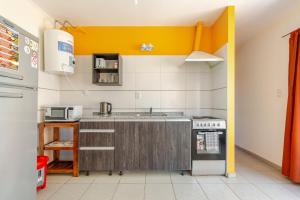a kitchen with a sink and a stove at Departamentos Brown in San Rafael +47 photos