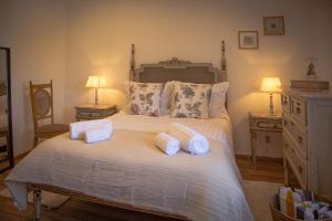 a bedroom with a large bed with towels on it at Monte do Trancoso in Alvito +17 photos